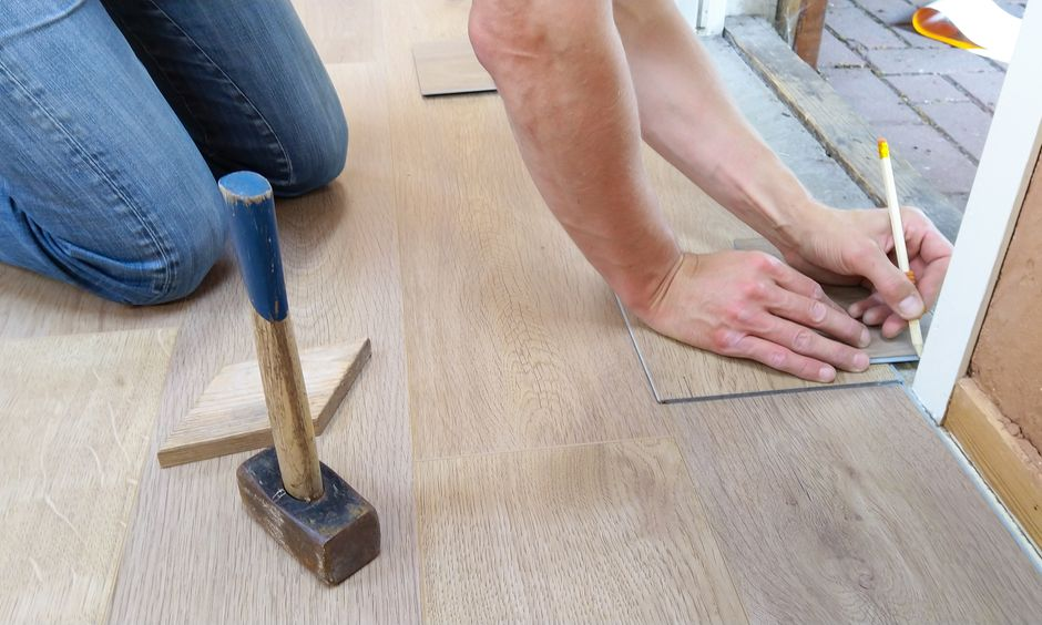 A homeowner or designer reviewing bathroom renovation plans and layout measurements for a primary suite.