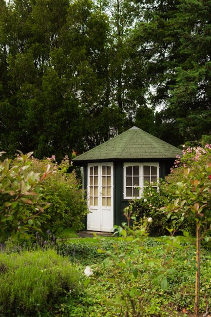 A small detached backyard dwelling behind a single-family home, showing separation from the main house.