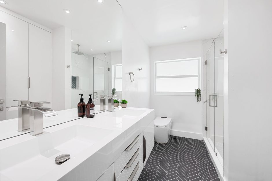 A contractor reviewing bathroom measurements and plans before renovation begins.