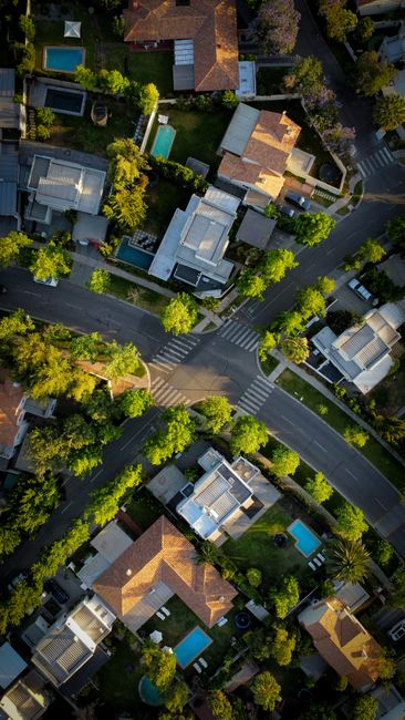 A backyard ADU beside a main house on a residential lot, illustrating how placement affects the rest of the property.