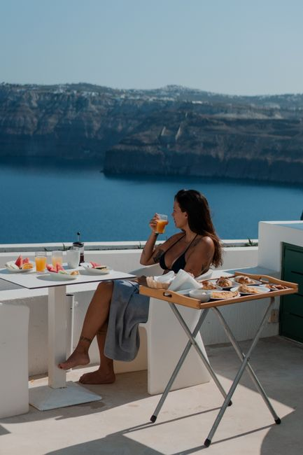 A quiet sea-view terrace at a coastal villa, overlooking the Aegean in soft morning light.
