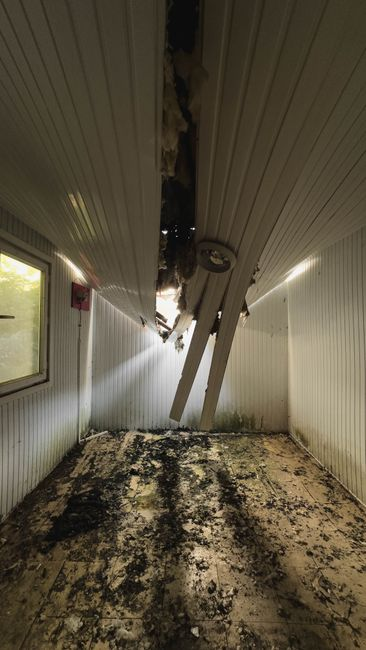 Drying equipment with air movers and a dehumidifier set up in a water-damaged room.