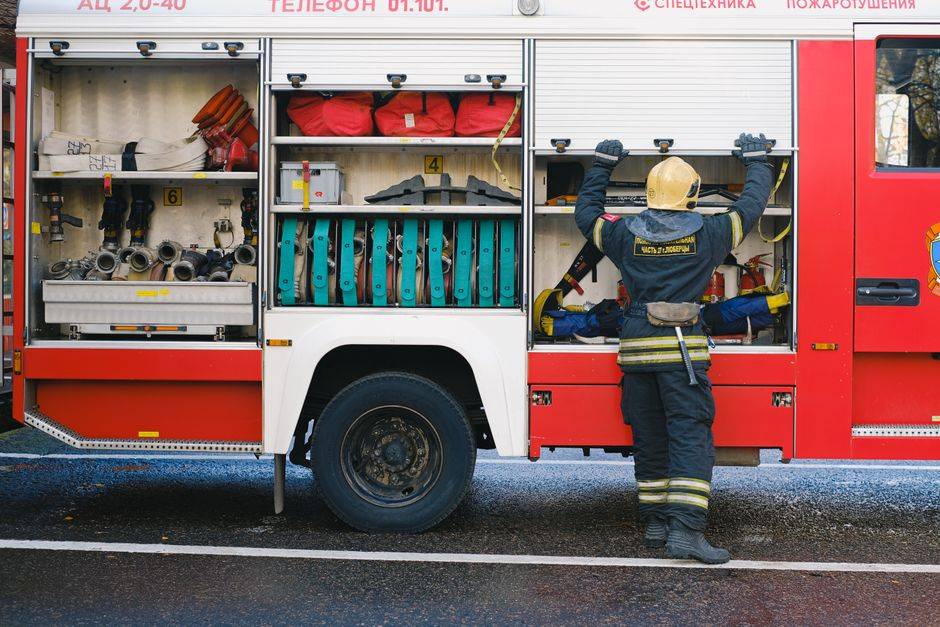 Restoration equipment removing water from a home's floor after firefighting efforts.