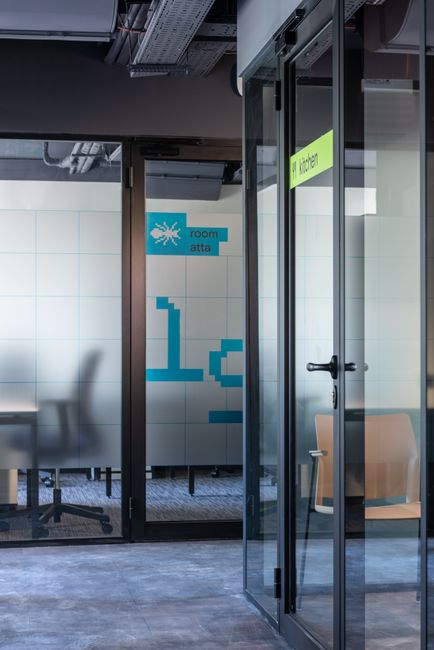 Modern office interior with a glass-walled conference room and clean, minimal partitions.