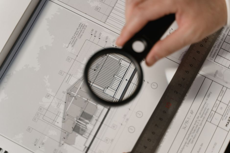 A contractor and designer reviewing renovation plans inside an older home.