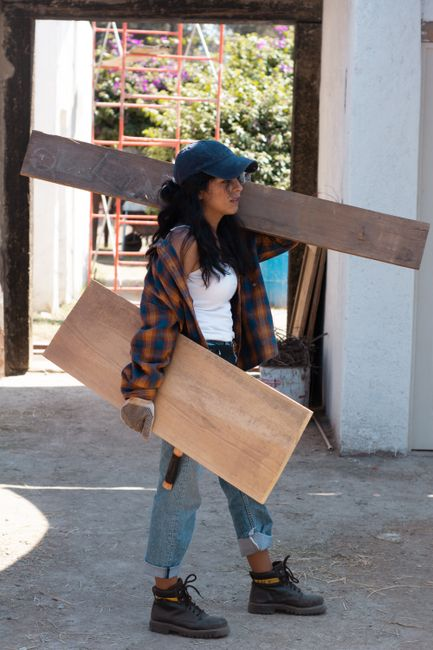 A contractor inspecting active renovation work at a home job site.