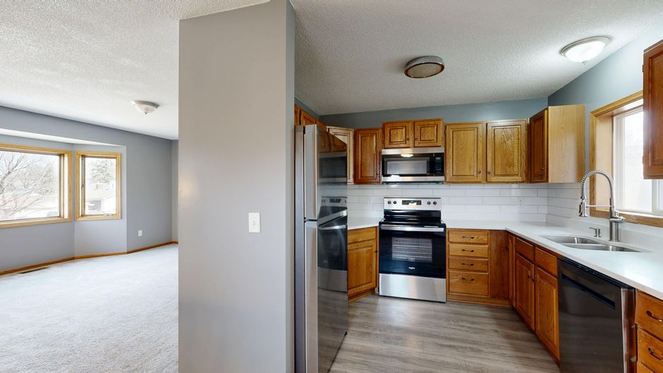 A kitchen under renovation with plastic dust barriers separating the work area from the rest of the home.
