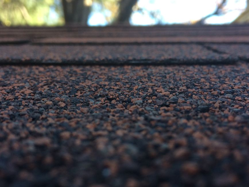Rainwater running through a roof valley on a sloped residential roof.