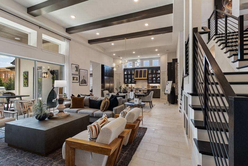 An open-concept kitchen connected to a living area and backyard doors, showing clear sightlines and easy circulation.