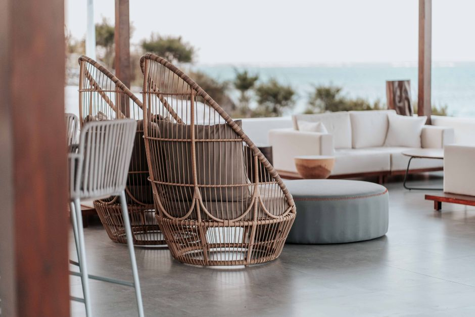 Modern Malibu beach house with large windows, ocean views, and a patio facing the coast.