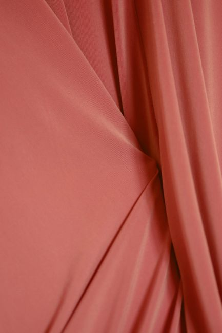 Different dressmaking fabrics such as chiffon, satin, and crisp woven cotton displayed for texture and movement comparison.