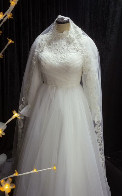 Close-up of a wedding dress illusion neckline and sleeves made with skin-toned mesh.