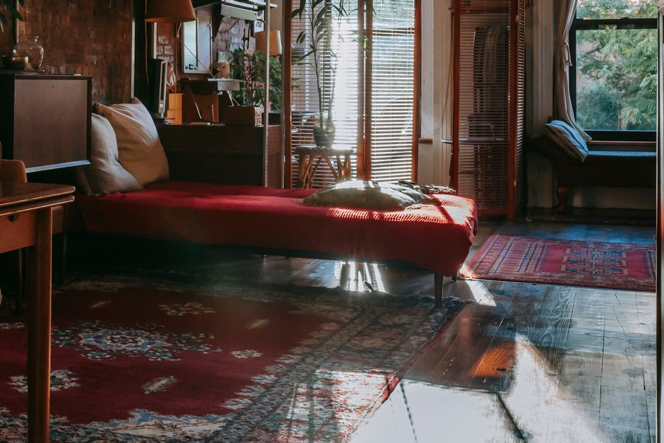Bright afternoon sun entering a bedroom through large windows, illustrating heat and glare in a priority room.