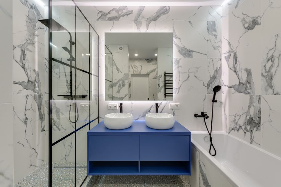A compact bathroom with a vanity, toilet, and shower arranged in a tight layout typical of an older home.