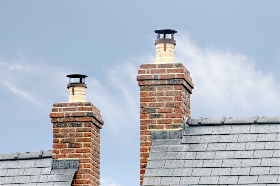 Close-up of metal flashing installed around a roof penetration and along a roof transition.