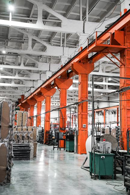 Interior of a commercial warehouse near a loading dock with wall-mounted utility lines and industrial surfaces.