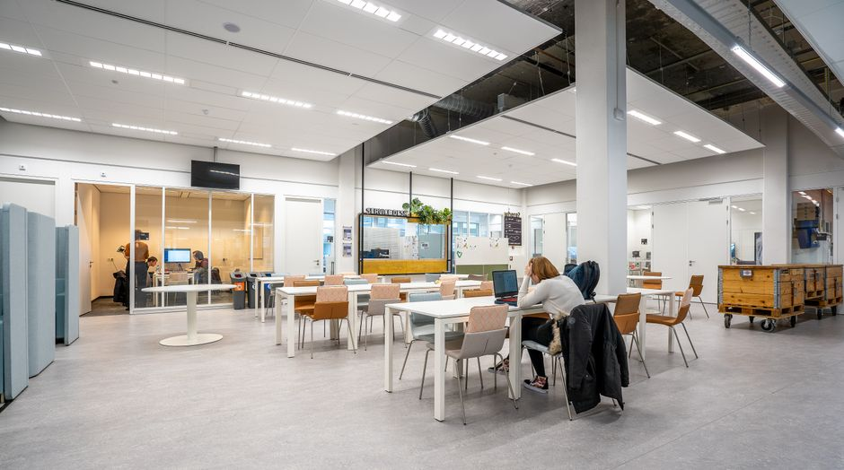 Modern office conference room with glass walls and a clean corporate interior layout.