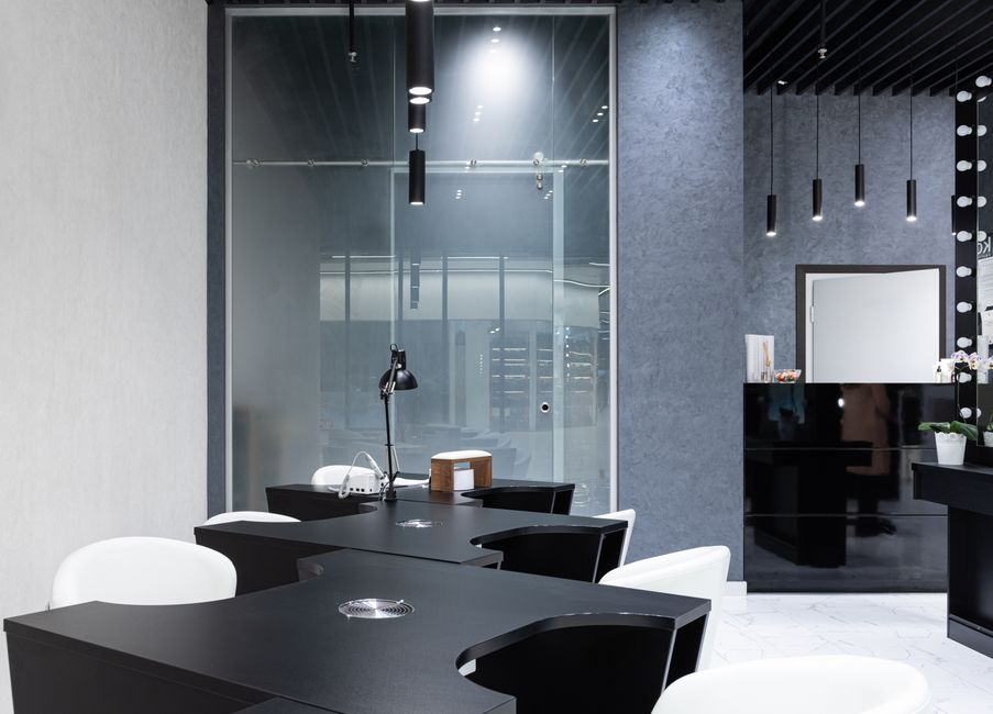 Client-facing office area near reception with glass-walled meeting space and open natural light.