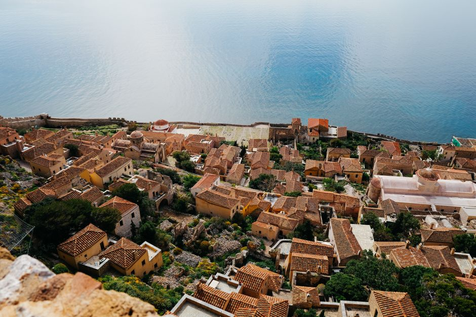 A historic stone village on a hillside overlooking the sea, with narrow lanes and dramatic views.
