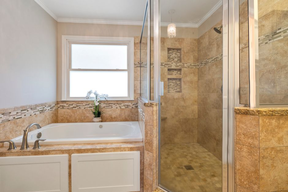 A renovated kitchen and bathroom shown as part of a coordinated home remodeling project.