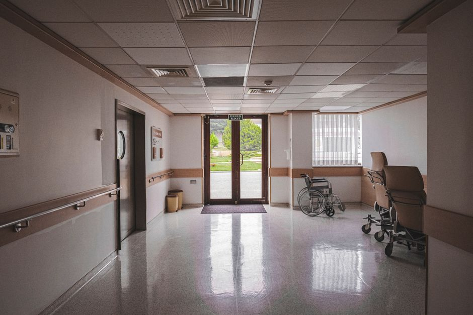 Modern hospital exam room with a glass partition that provides privacy while keeping the space bright and uncluttered.
