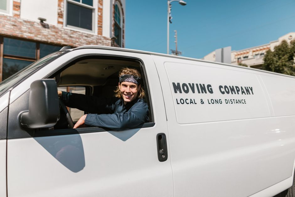 An employee driving a car during a work-related trip in an urban area.