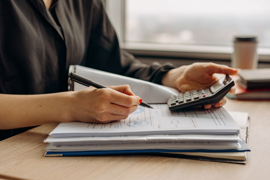 Car keys, insurance paperwork, and a household budget worksheet on a table.