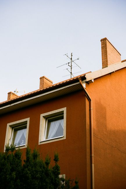 Residential roof edge with drip edge metal meeting a gutter along the eave.