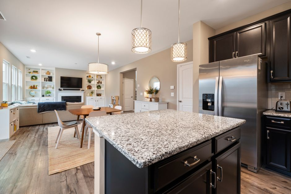 A modern kitchen with an island and clear walkways showing how prep, seating, and circulation interact.