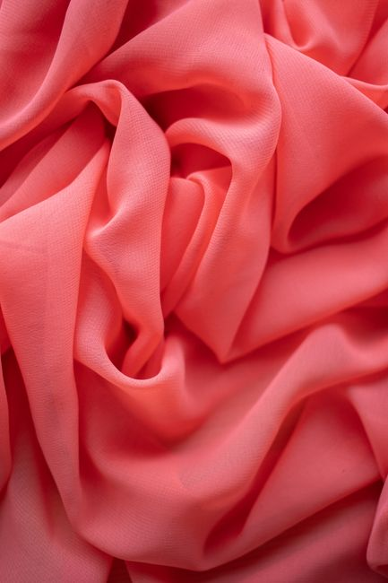 Soft jersey knit fabric draping in loose folds to show fluid movement and a lightweight hand.