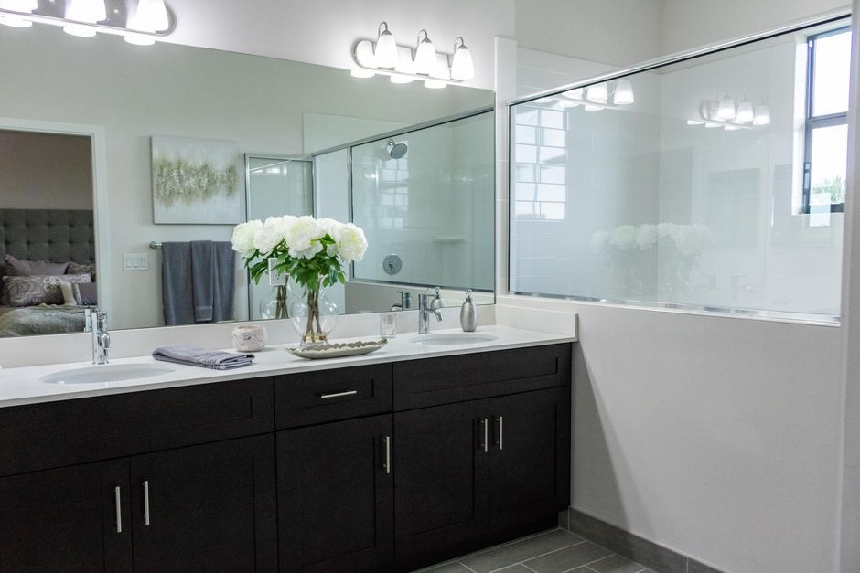 A bright modern bathroom with a glass shower enclosure and large window that emphasizes openness and privacy concerns.