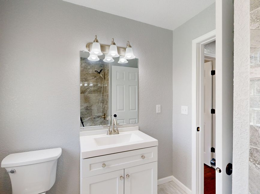 Bathroom tile samples, fixture finishes, and vanity materials laid out for selection.