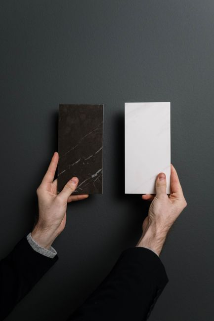 Bathroom tile and finish samples arranged beside a vanity or countertop for remodeling selections.
