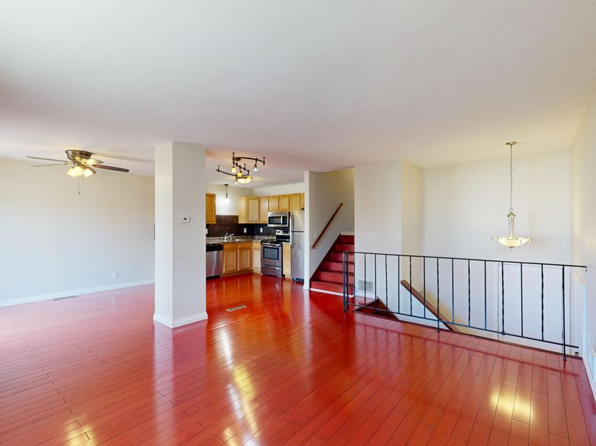 A bright open-concept kitchen with an island flowing into the adjacent living area.
