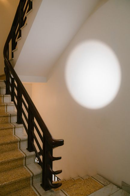 A residential staircase with sturdy handrails, clear tread visibility, and good lighting in a home setting.