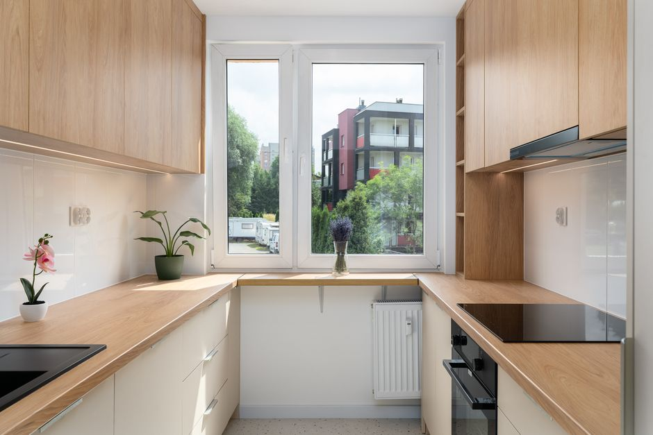 A well-organized kitchen with smart storage, clear walkways, and a compact island within an unchanged footprint.