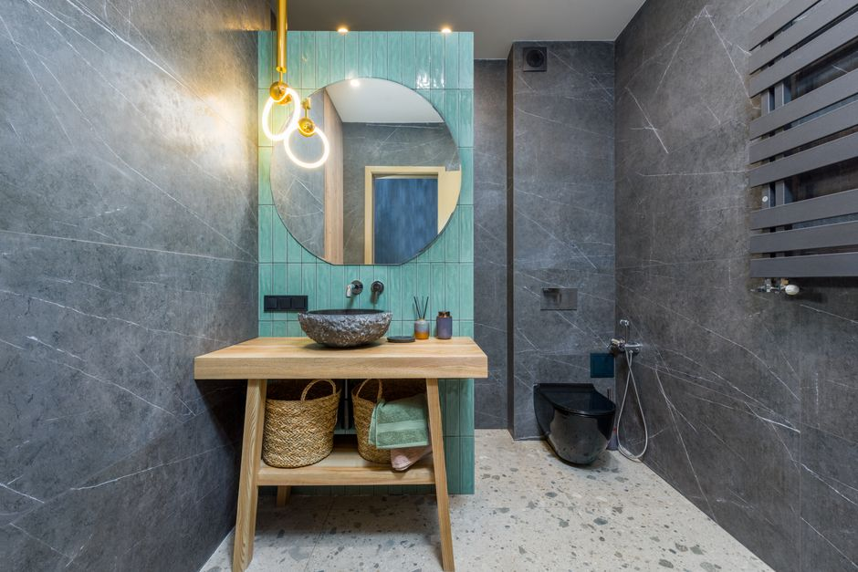 A bathroom vanity with mirror lighting and soft layered illumination around a modern sink area.