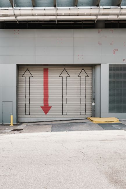 An active commercial property with a loading dock, vehicle access, and building entrances that would need coordination during construction.