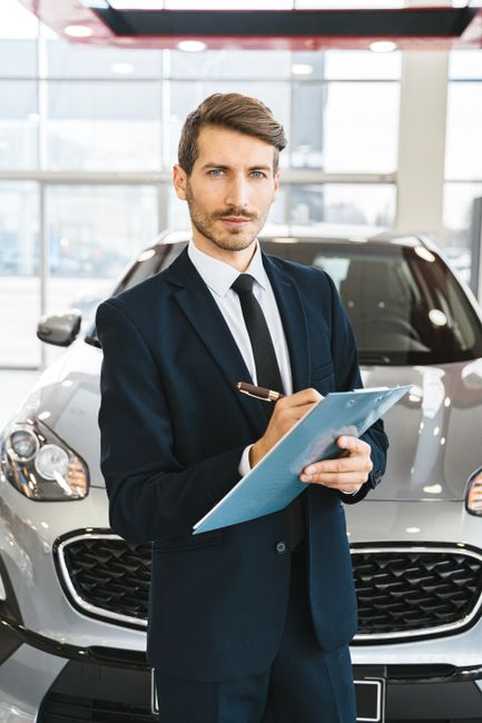 A dealership service advisor speaking with a customer about a vehicle service appointment.