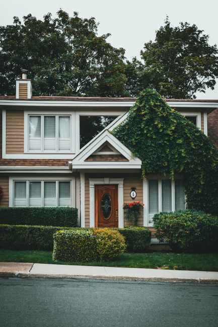 A tidy side yard with trimmed vegetation and clear space along the exterior wall of a house.