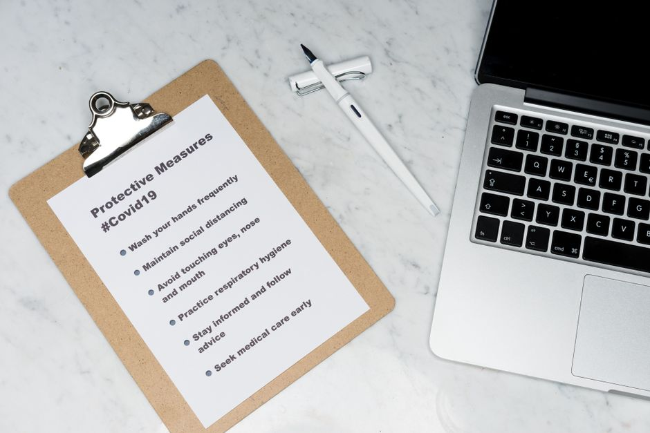 An auditor or quality manager reviewing a checklist in a clean industrial or food facility.