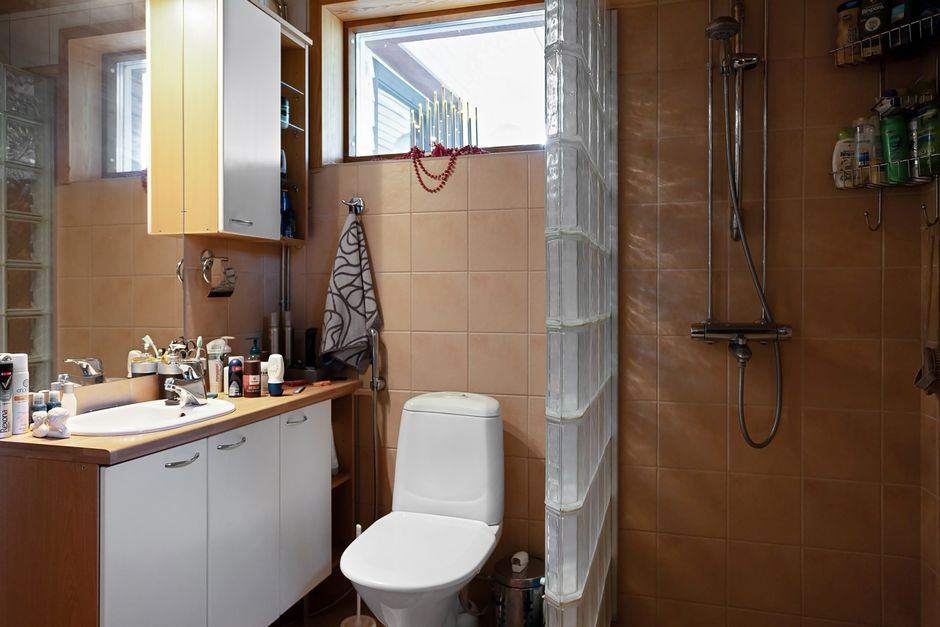 Bright modern bathroom with a large window and glass shower enclosure that emphasizes daylight and privacy needs.