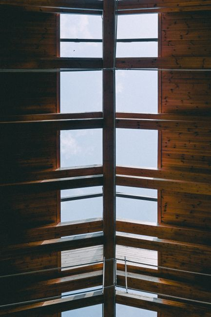 Minimalist home interior with a prominent skylight bringing daylight into the room from above.