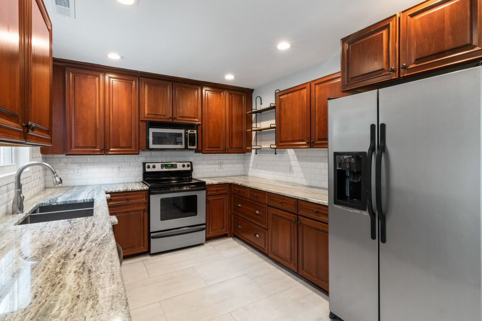 A kitchen mid-remodel with cabinets and finishes being updated while the general layout remains intact.