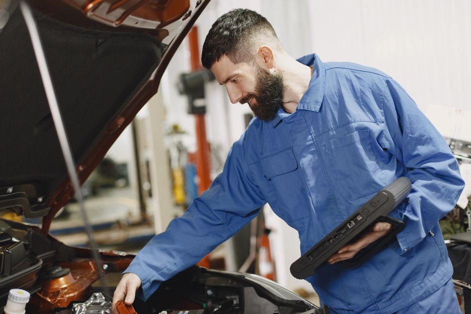 A dealership staff member inspecting a vehicle during a trade-in appraisal.