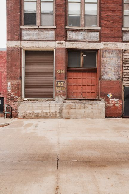 Exterior view of a commercial warehouse loading dock and access doors where rodent intrusion risk is often evaluated.
