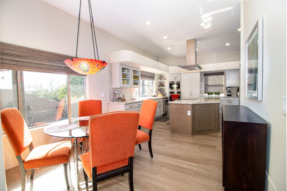 A modern kitchen with a large island and clear walkways around appliances and prep areas.