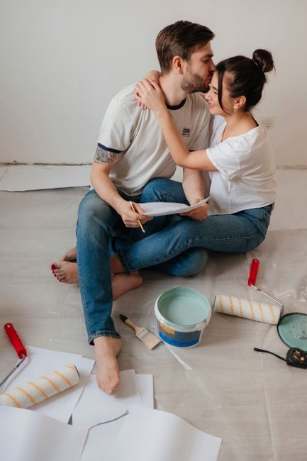 Homeowners reviewing renovation estimates and notes at a table.
