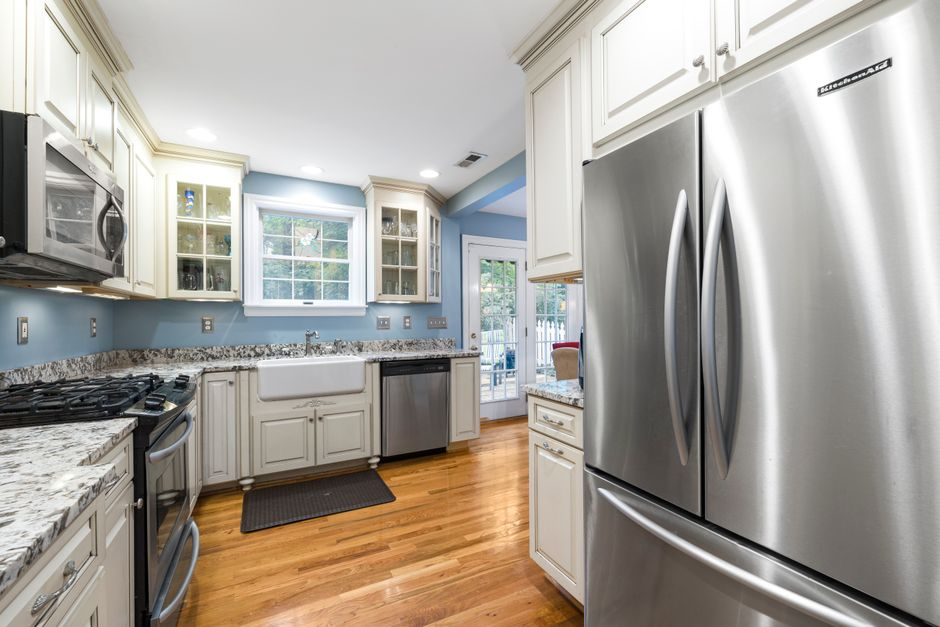 A compact kitchen where narrow walkways and appliance placement create circulation challenges.