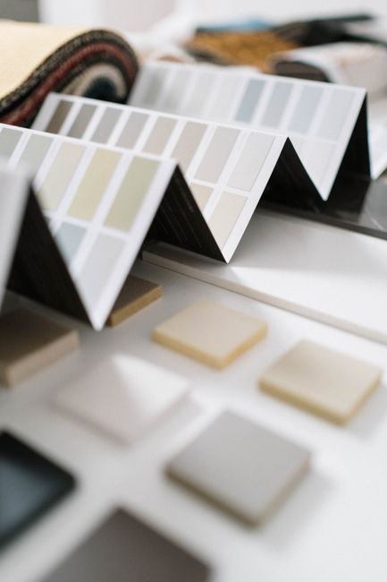 Fabric swatches arranged beside a table runner on a reception-style table setting.